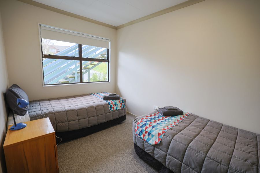 Two single bed, red patterned throw and fresh towels